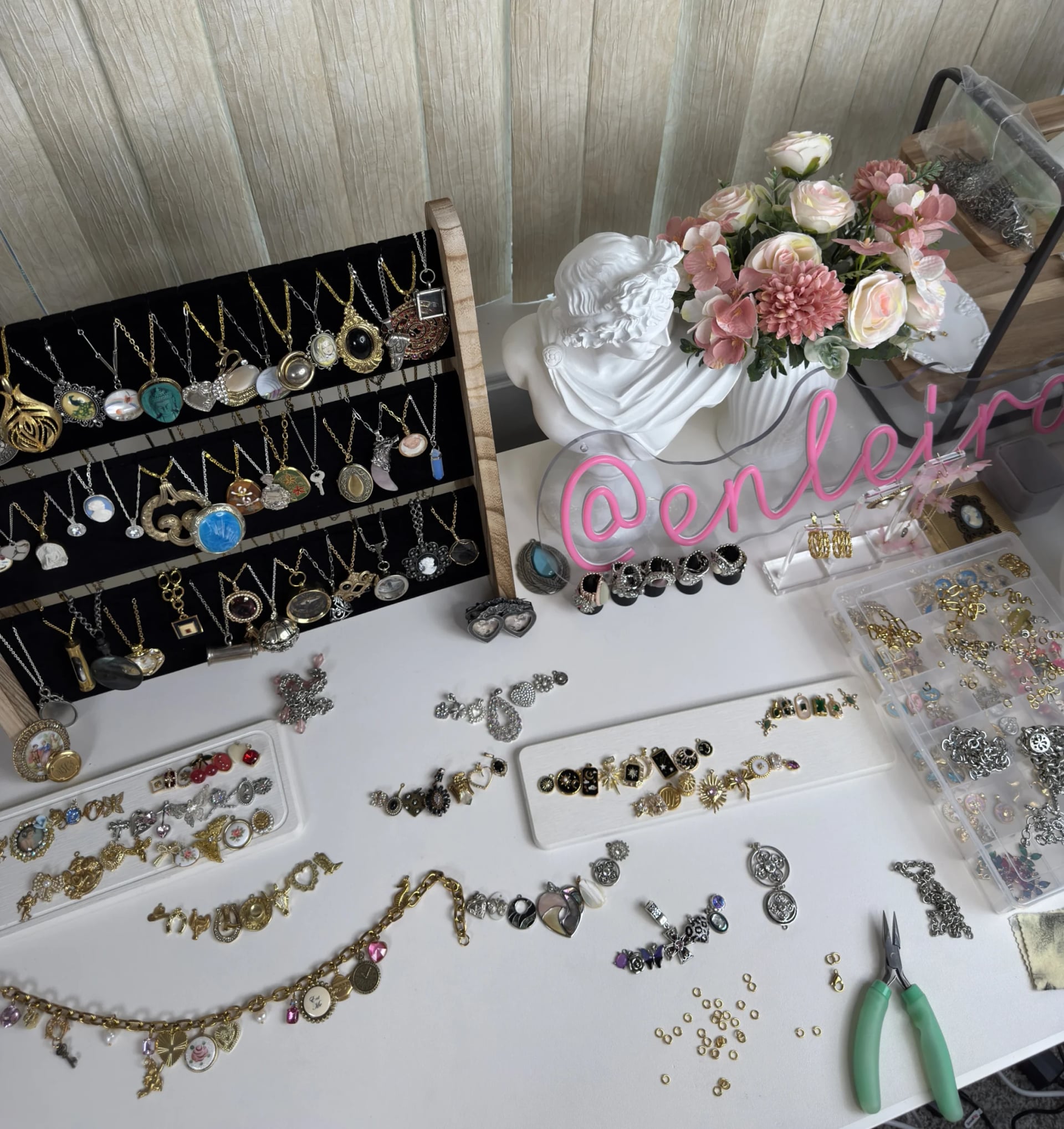 An elegant workspace with handcrafted gold plated and stainless steel charms being assembled into jewelry, by Enleira